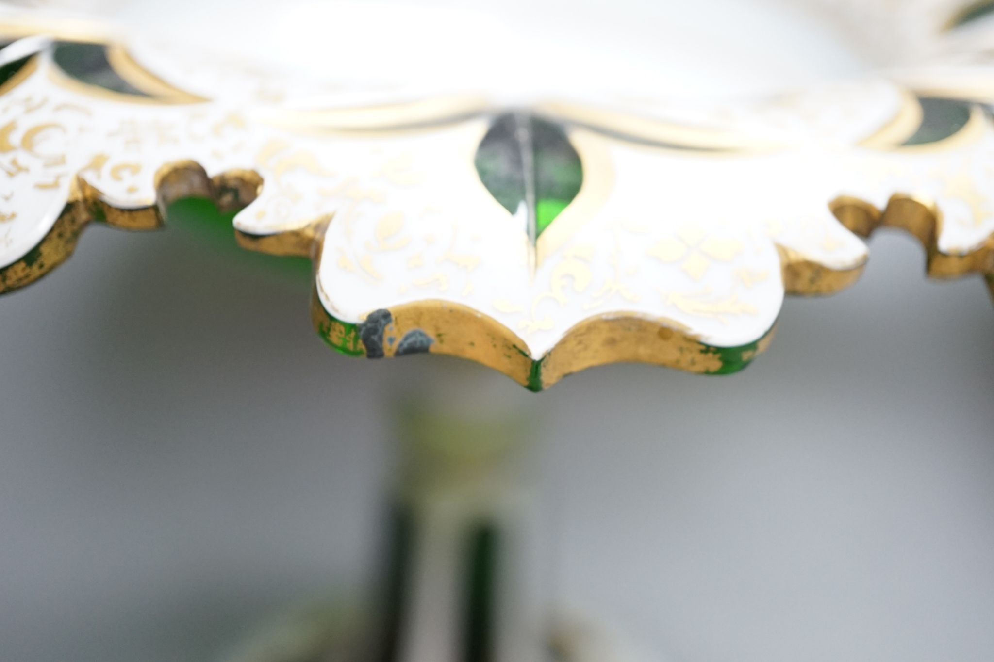 A 19th century overlaid green glass comport, 24cm high, and a similar table lustre